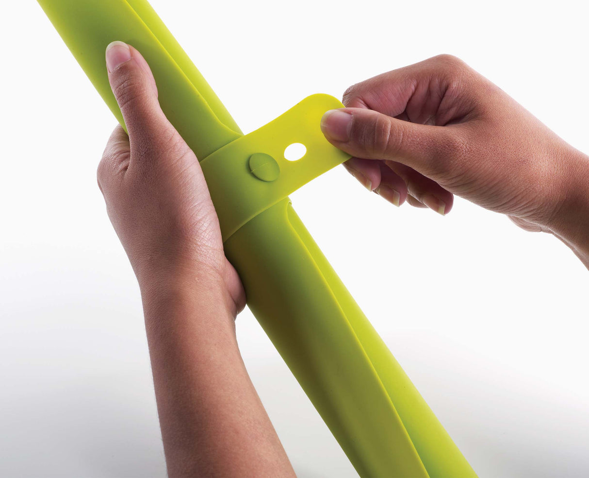 The mat rolled up with its integrated strap locked around it.
