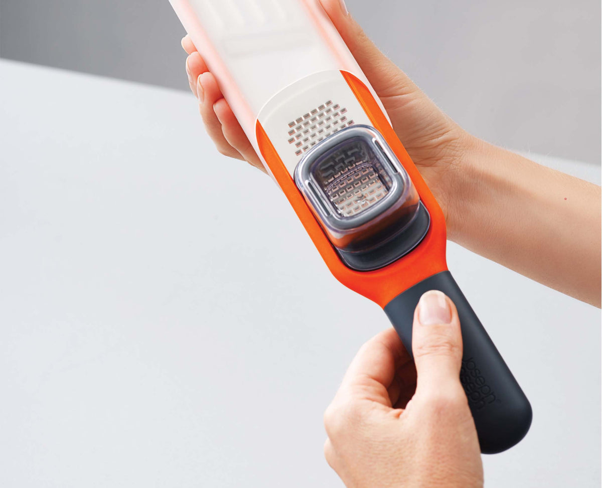 The sliding finger guard in position to protect fingertips while grating.