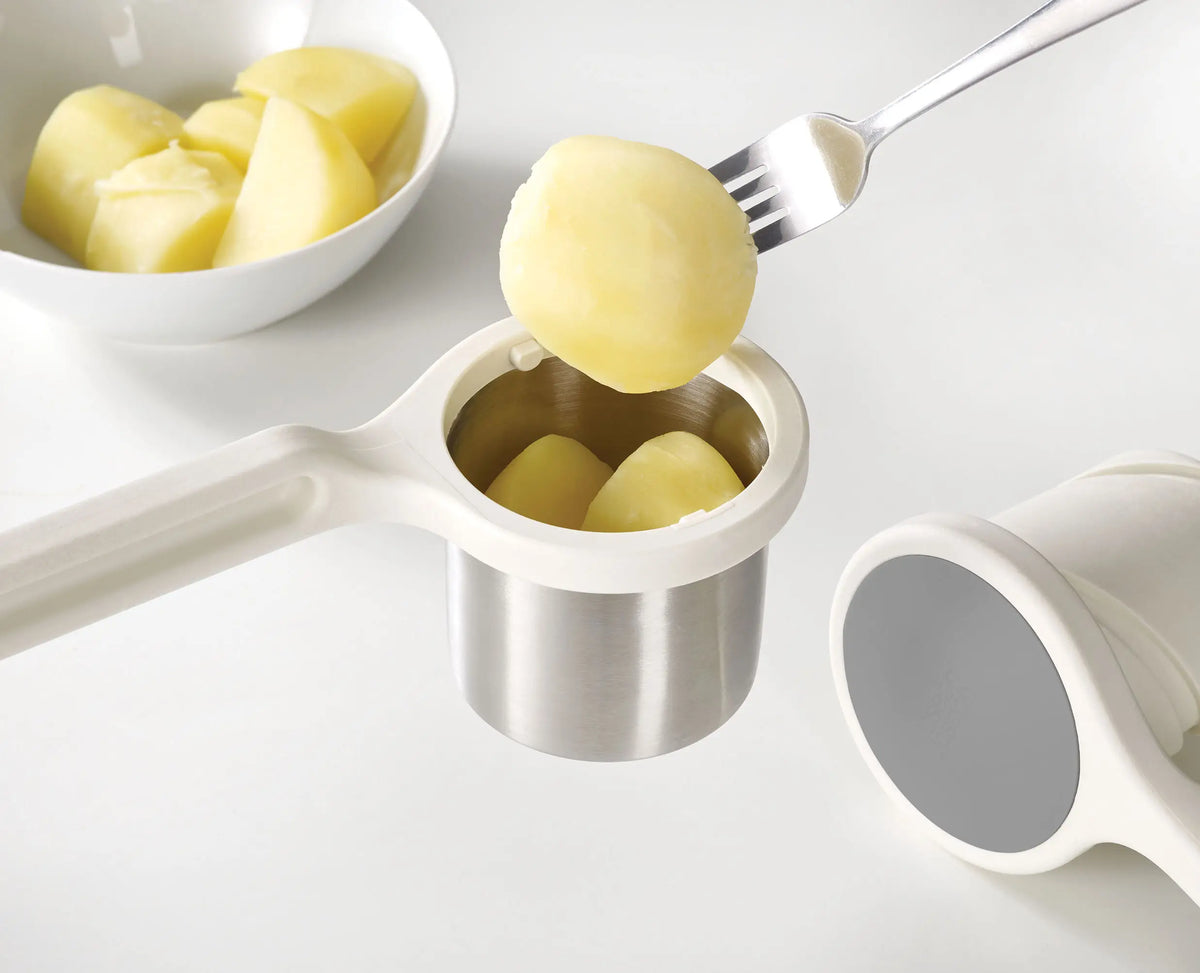 Joseph Joseph Helix potato ricer in use in a kitchen