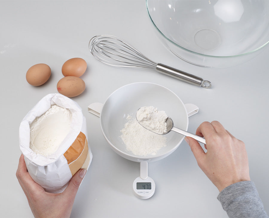 The white TriScale folded closed into its compact shape for drawer storage