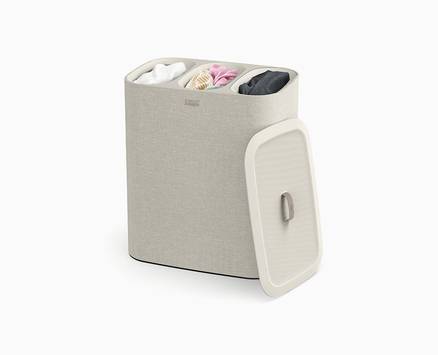 Joseph Joseph Tota Trio 90L laundry basket in ecru with the lid in place.
