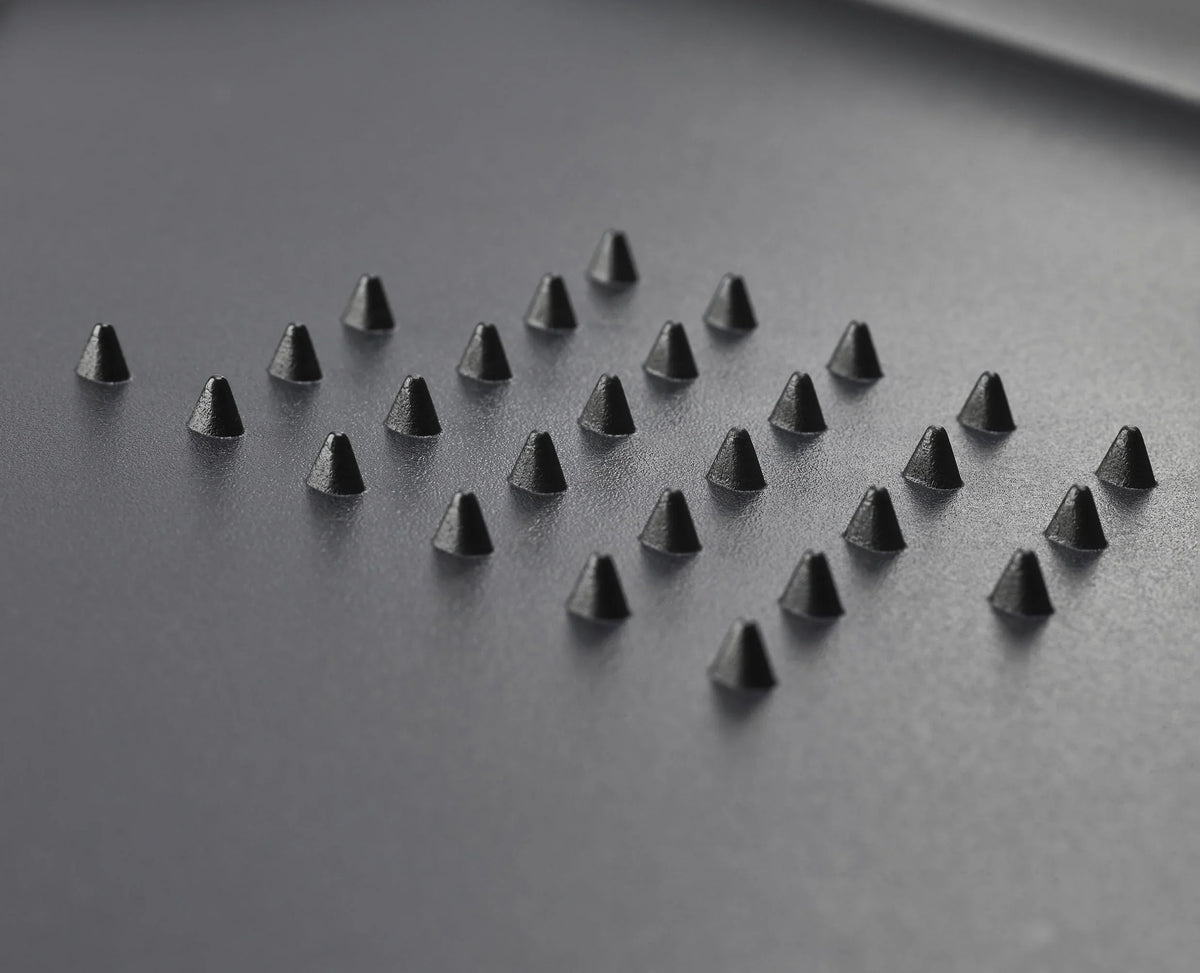 The black extra-large board in use on a kitchen worktop.
