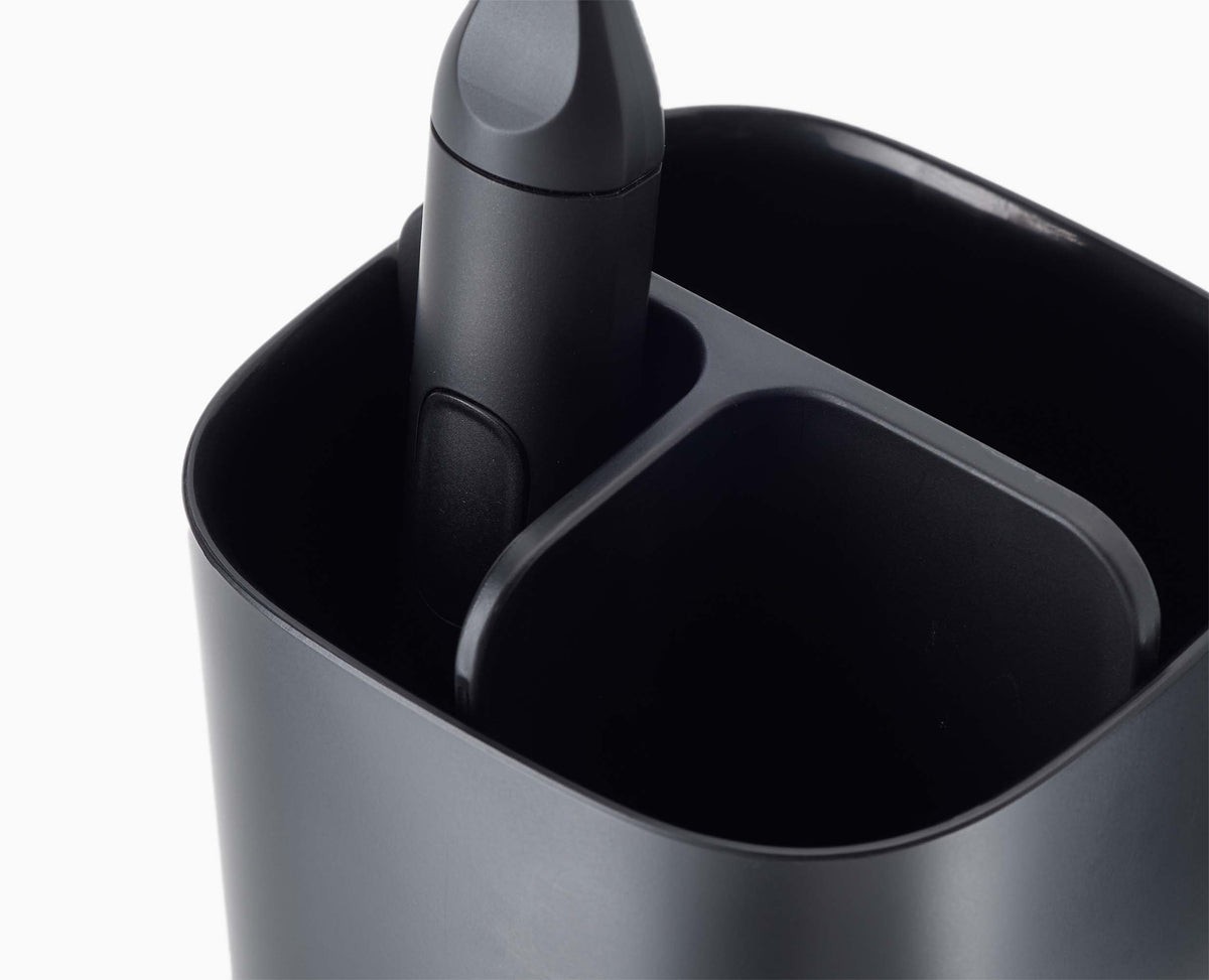 The toothbrush holder dismantled into its parts for cleaning.