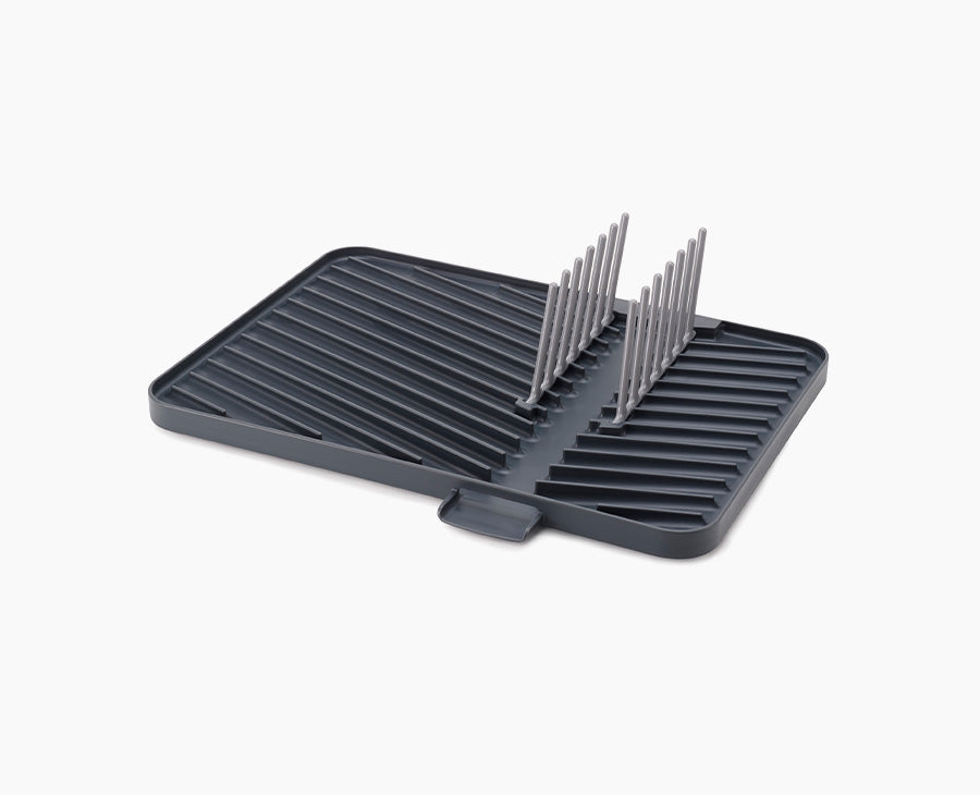 Joseph Joseph Flip-Up draining board in grey with the plate rack raised.