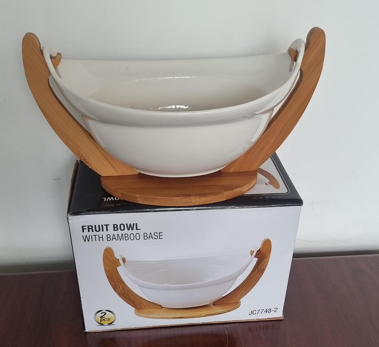 Ceramic fruit bowl on bamboo base