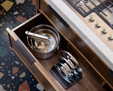 Joseph Joseph Space Steel saucepans stored in a cupboard with the pan lid stand