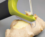 The green Y-shaped peeler angled to show its stainless-steel straight blade