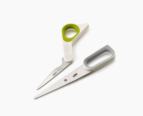 PowerGrip kitchen scissors cutting through food on a board