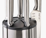 Close-up of a knife held magnetically against the rotating steel block