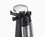 Close-up of a silicone utensil head and its weighted stainless-steel handle