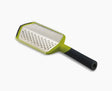 Joseph Joseph Twist Grater in green with its coarse and fine blade faces.