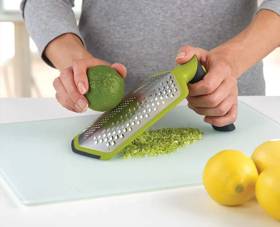 The Twist Grater with its handle set straight for grating over a bowl.