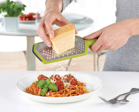The Twist Grater standing on its non-slip feet on a worktop.