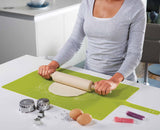 The green baking mat used as a non-slip surface for rolling out pastry.