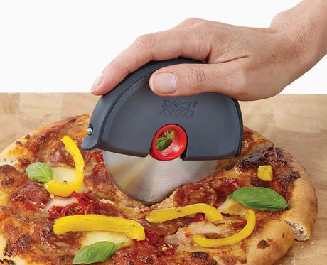 The Disc pizza wheel rolling through a pizza in a single pass.