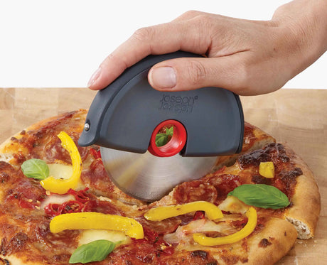 The circular stainless steel blade lifted out of the Disc pizza wheel for cleaning.
