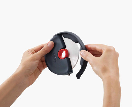 The pizza wheel held in one hand, showing the ergonomic grip position.