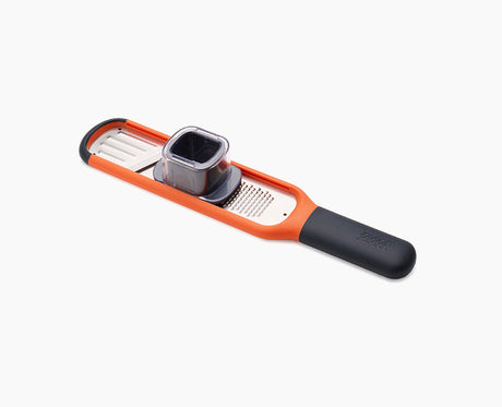 Joseph Joseph Handi-Grate 2-in-1 mini grater and slicer in orange.