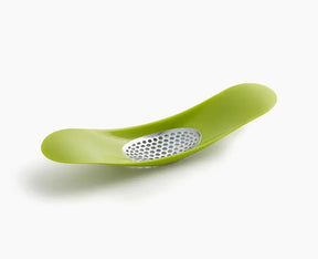 Joseph Joseph Rocker garlic crusher in green, shown from above.