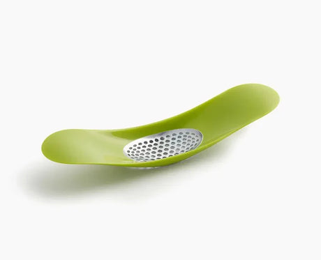 Joseph Joseph Rocker garlic crusher in green, shown from above.