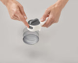 The integrated hook on the Can-Do Plus lifting a ring-pull tab.