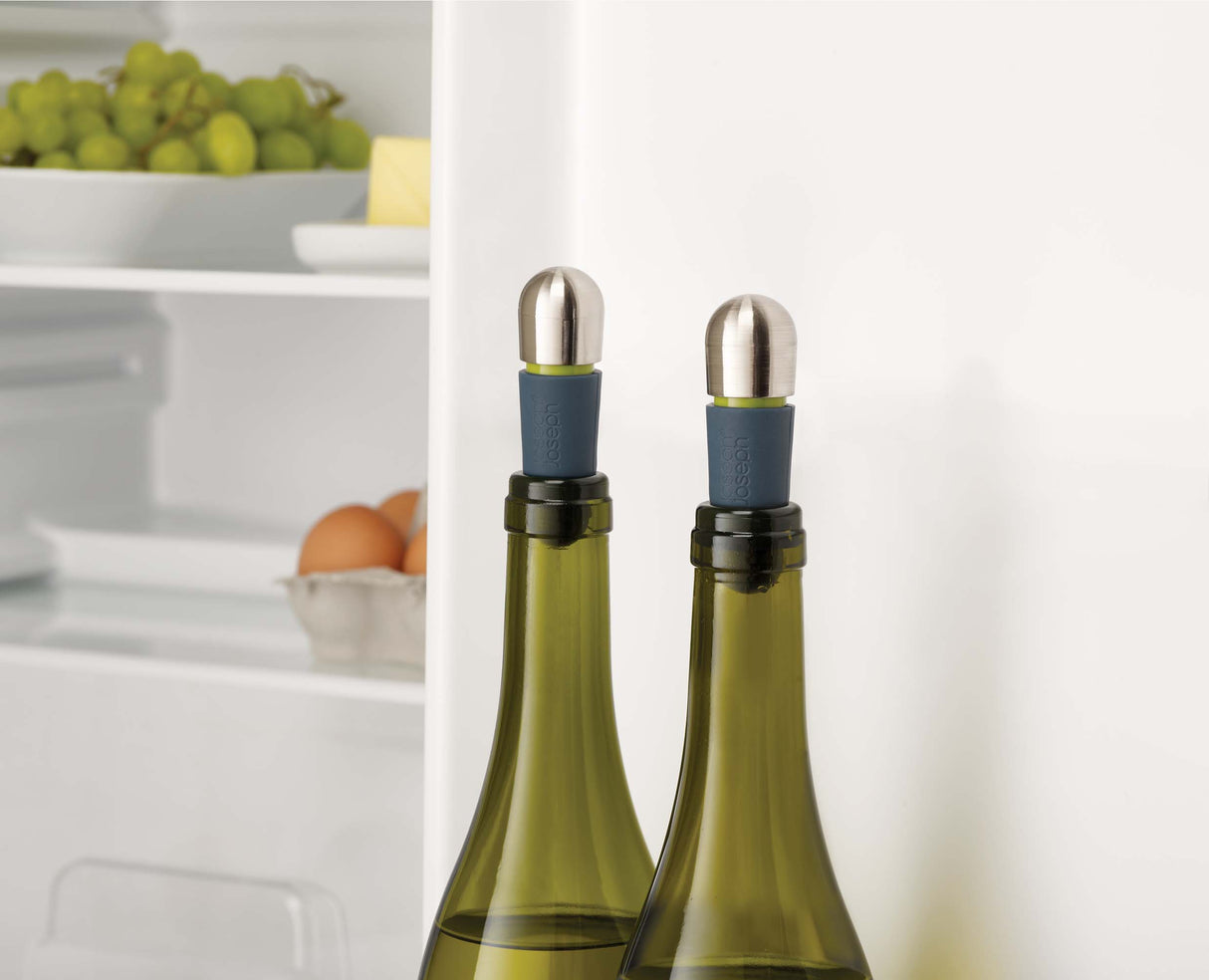 A hand twisting the cap to lock the stopper into the bottle neck.