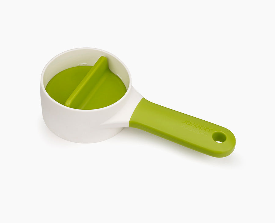 Joseph Joseph SpiroGo compact hand-held spiralizer in green.
