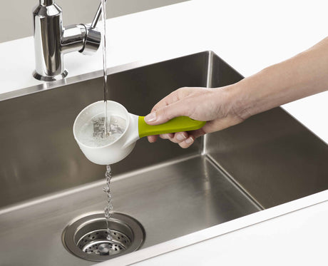 The detachable finger guard with food grip fitted to a vegetable.
