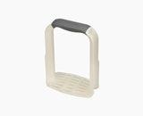 Joseph Joseph Easy-Mash potato masher in white with its D-shaped handle.