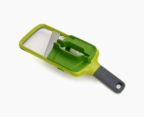 Joseph Joseph Multi-Grip Mandoline in green with its food grip attached.