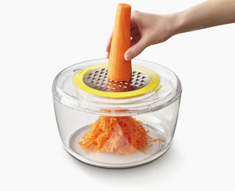 Multi-Prep finger guard holding a vegetable for safe slicing.
