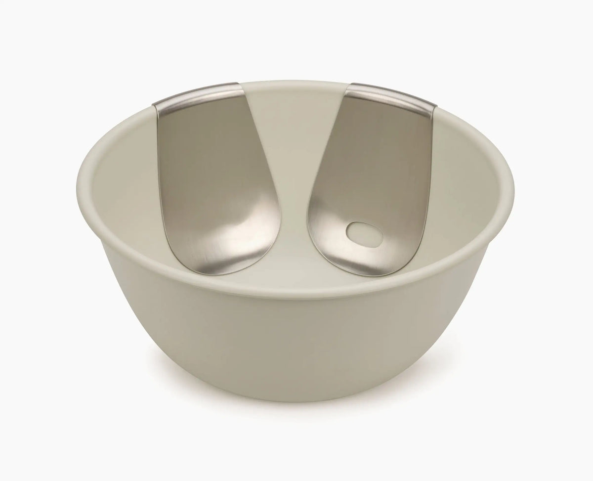 Uno salad bowl and servers set styled on a dining table.