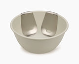 Uno salad bowl and servers set styled on a dining table.
