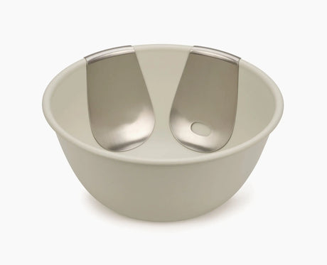 Uno salad bowl and servers set styled on a dining table.