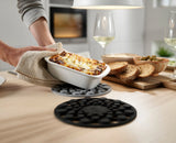 A hot pan resting on a Spot-On silicone trivet.