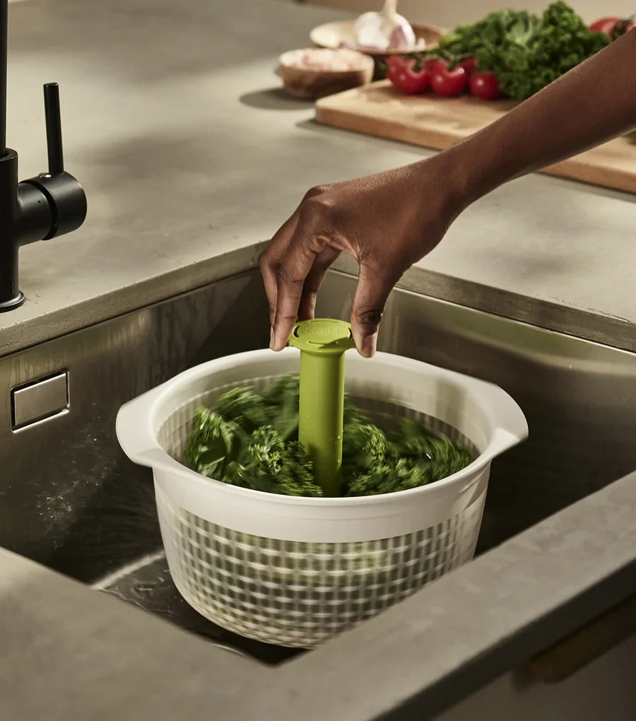 Joseph Joseph Spindola colander attached to the sink base with its suction cup