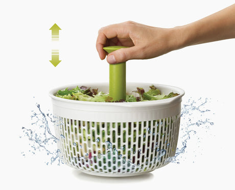 Joseph Joseph Spindola green colander in use rinsing vegetables in the sink