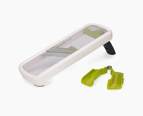 Joseph Joseph Multi-Grip Mandoline Plus in white, set up for slicing.