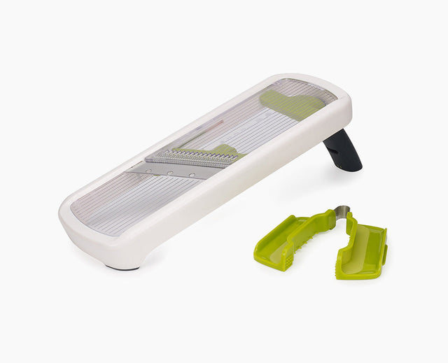 Joseph Joseph Multi-Grip Mandoline Plus in white, set up for slicing.