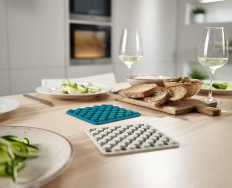 Joseph Joseph Duo silicone trivets set of two in opal and stone under a hot pan, Homelux Kenya