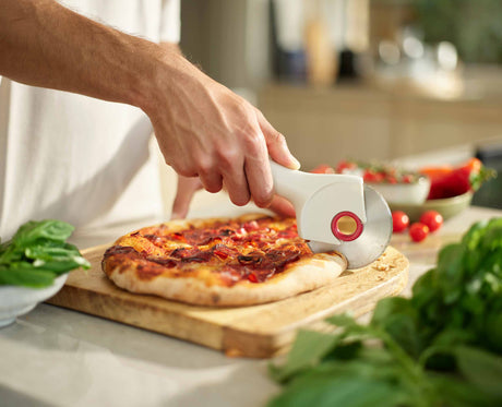 Joseph Joseph Ringo pizza cutter in stone and red blade pulled out of the handle for cleaning, Homelux Kenya