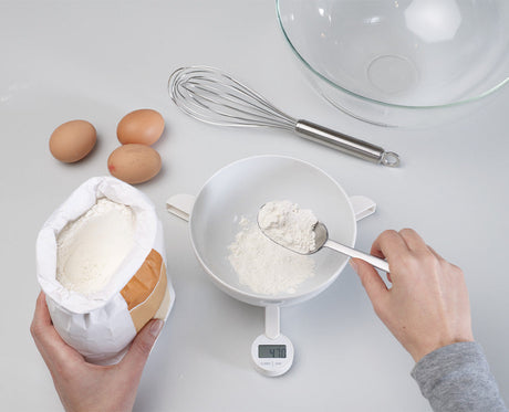 The white TriScale folded closed into its compact shape for drawer storage