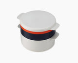 Joseph Joseph M-Cuisine 4-piece microwave cooking set stacked together in stone and orange