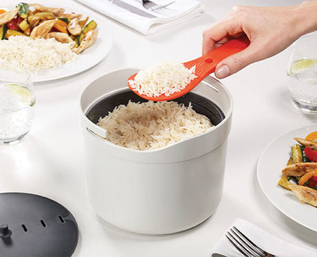The rice cooker set separated to show the 2L pot, colander, measuring cup and paddle