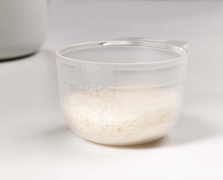Close-up of the measuring cup used to portion out dry rice