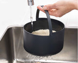 Cooked rice being fluffed and served with the multi-purpose paddle