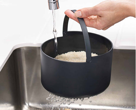 Cooked rice being fluffed and served with the multi-purpose paddle