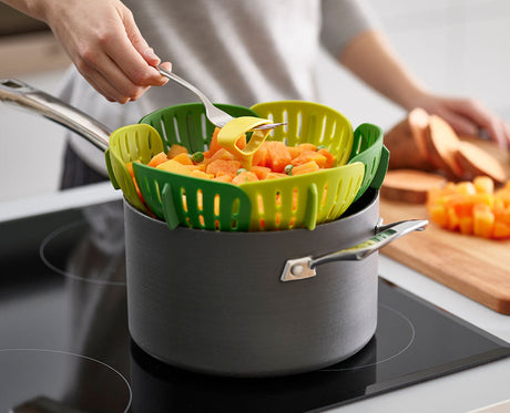 The steamer basket folded closed into a compact disc for storage