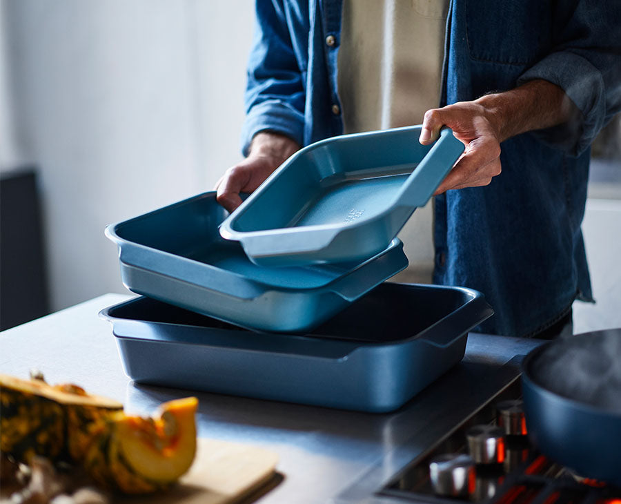 The three blue roasting trays separated to show the large, medium and small sizes