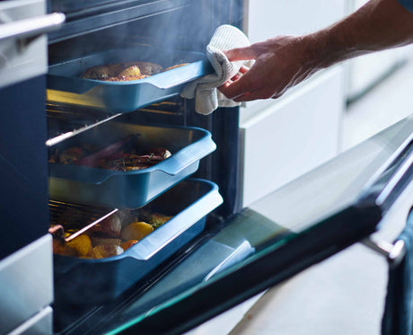 The Nest Oven roasting trays in use in a kitchen